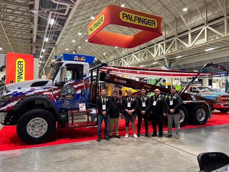 Teeam at a trade show in front of their truck
